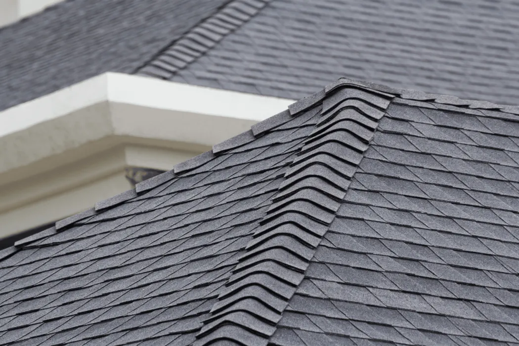 Close-up view of a roof with dark architectural asphalt shingles layered for a dimensional look