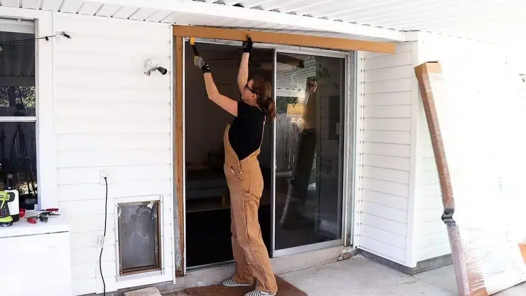 a woman installing a sliding door