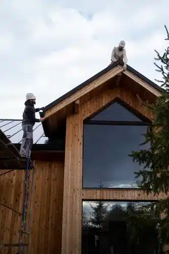 Bristol builder team working on the roof of a modern wooden house