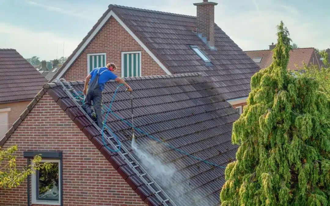 a roofing expert washing the roof