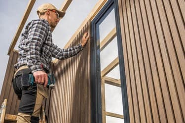Construction Worker Building Modern Composite and Wood Made Shed in providence