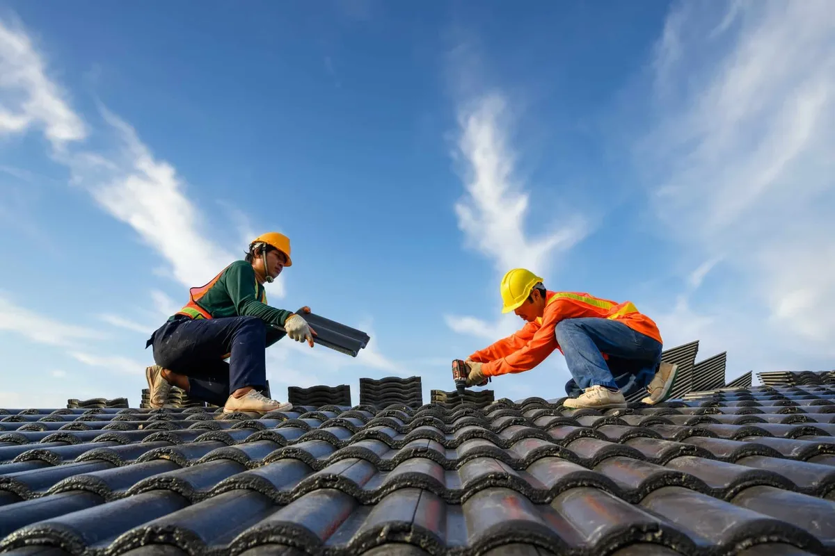 two workers installing roof in East Providence