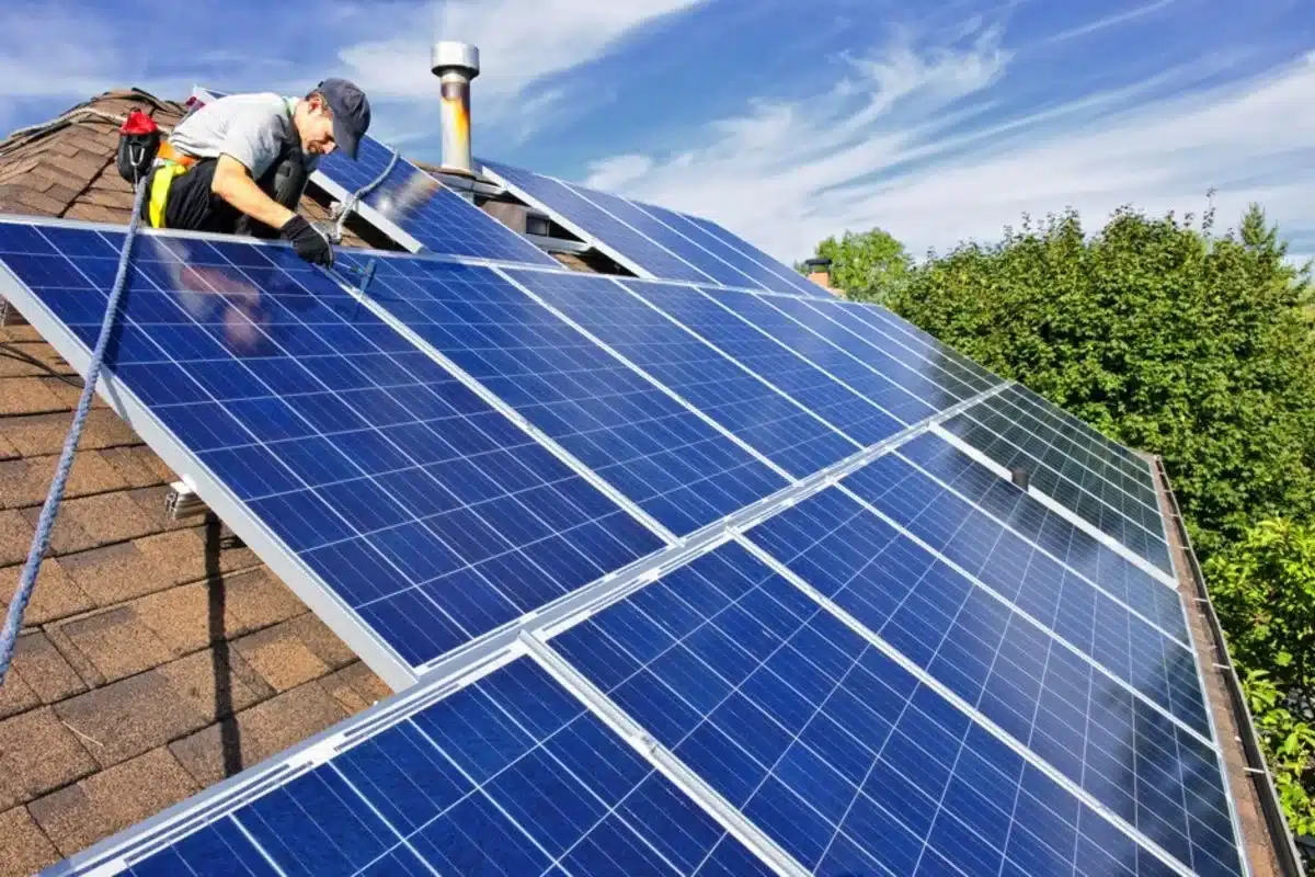 an expert installing solar panels on roof