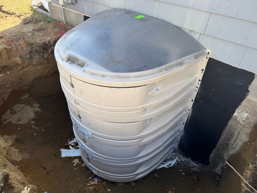 An egress window well dug out during a GCR egress window installation in Rhode Island.