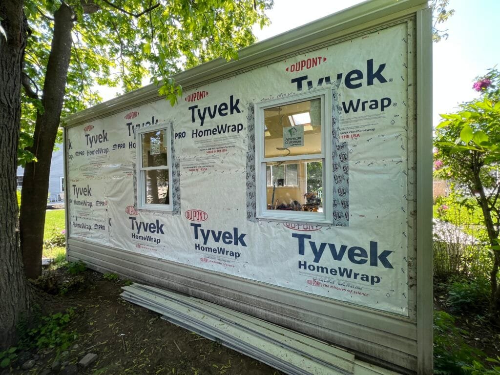 House wrap and window flashing integrated before siding.