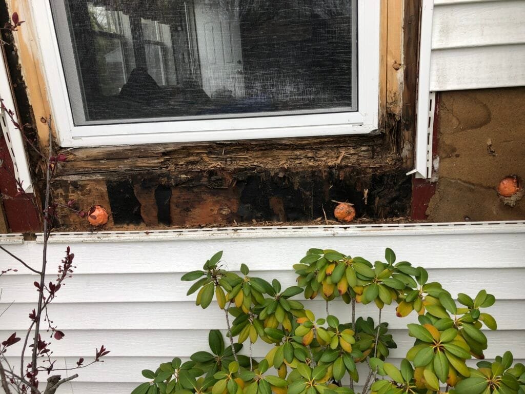 rotted window frame caused by improper flashing and water intrusion Rhode Island