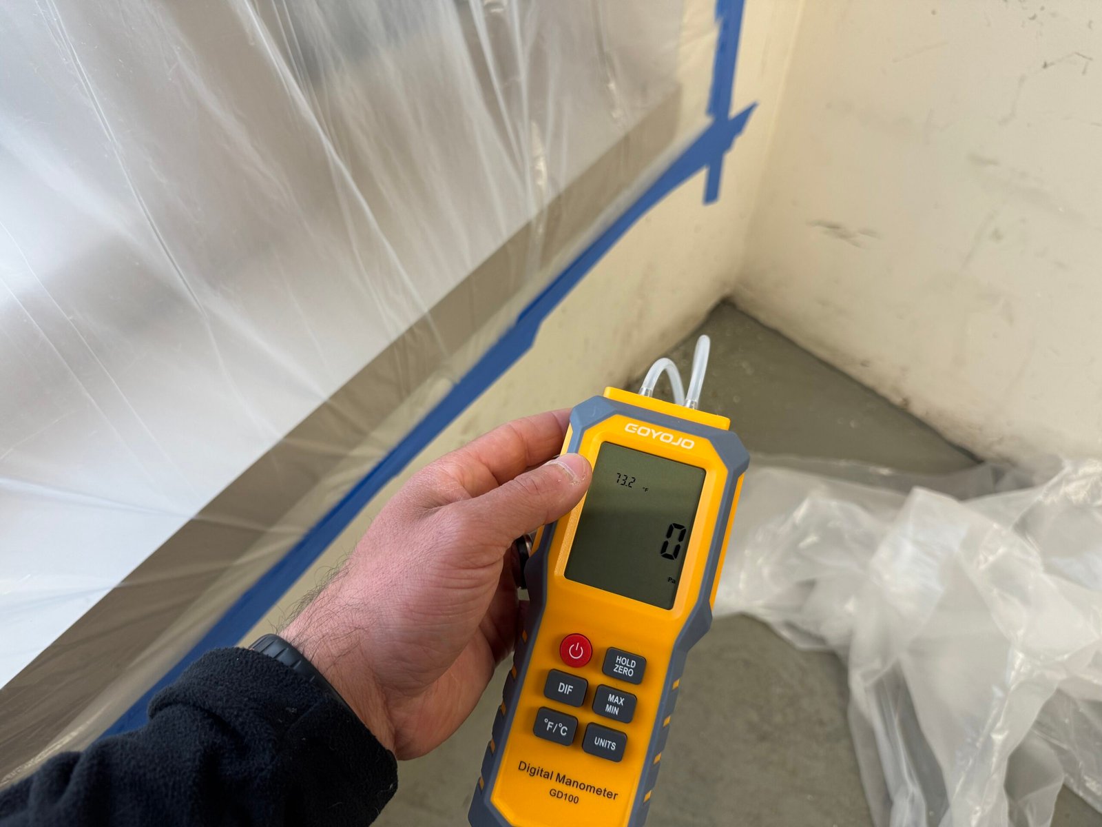 Moisture meter testing at a building enclosure transition during a water intrusion investigation.