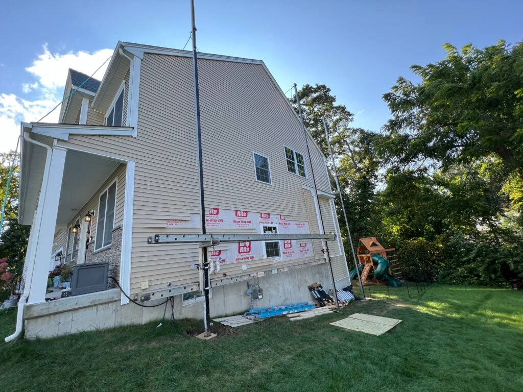 Siding going on over a properly wrapped wall.